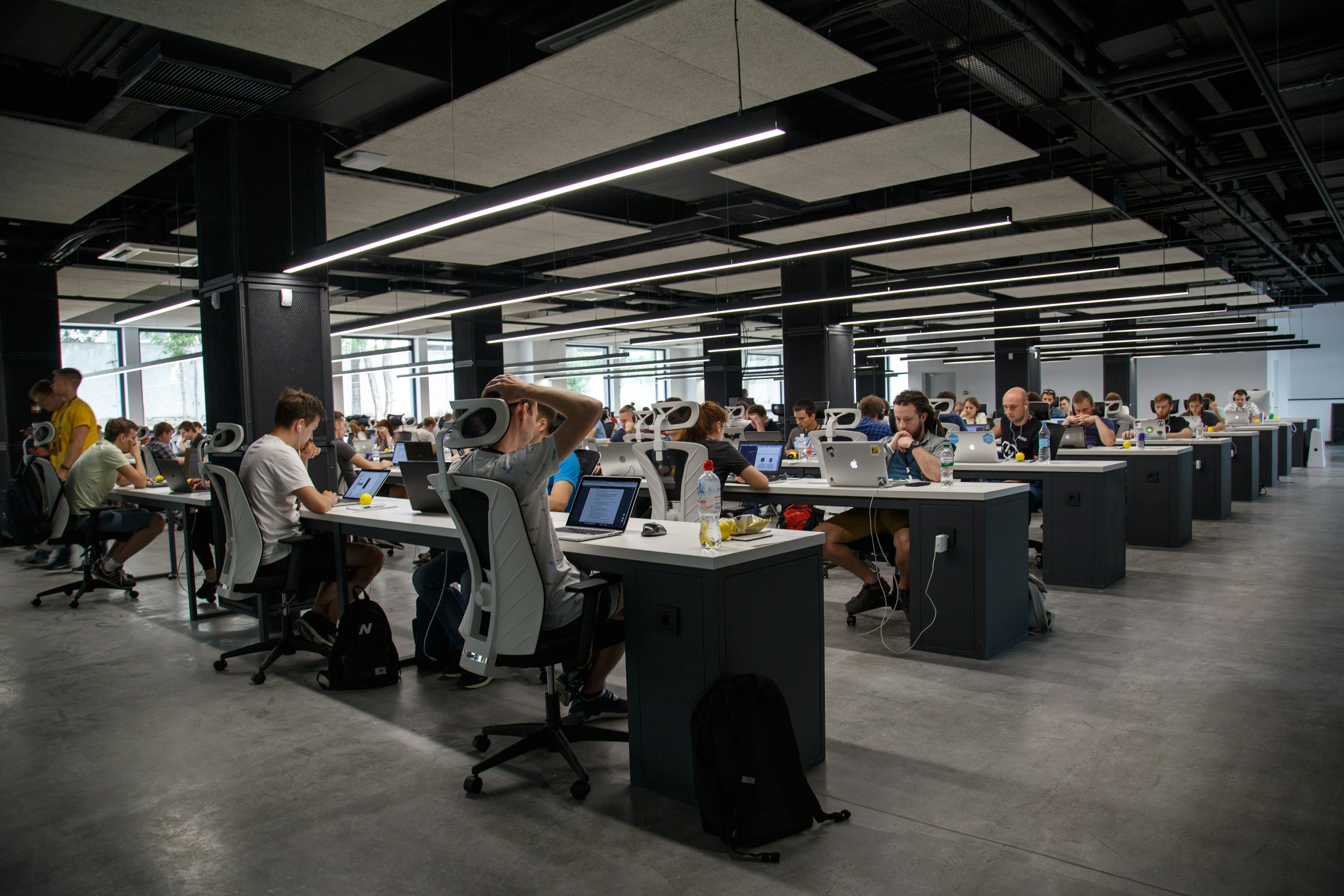 A large shared workspace with many people and computers